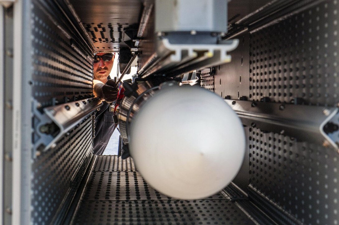 Navy Chief Petty Officer Joseph Tsicouris loads an Evolved Sea Sparrow missile into a NATO Sea Sparrow launcher on the missile deck of the USS America in the Pacific Ocean, July 20, 2017, during the ship’s maiden deployment. Navy photo by Petty Offier 2nd Class Alexander A. Ventura II