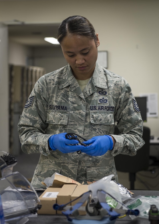 Tech. Sgt. Jacklyn Sugiyama, 120th Operations Support Squadron, Montana Air National Guard, builds quick-dawn masks, July 18, 2017, at Yokota Air Base, Japan. The masks will be used on all of Yokota’s C-130J Super Hercules models. (U.S. Air Force photo by Airman 1st Class Juan Torres)