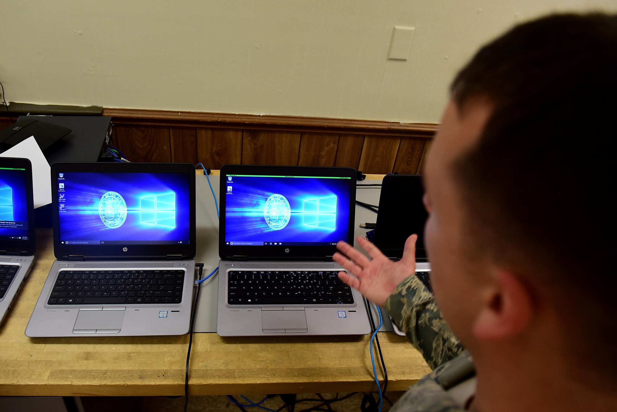 Airman 1st Class Joshua Burton, 4th Communications Squadron client services technician, discusses the process of migrating every computer on Seymour Johnson Air Force Base, North Carolina, to a new Windows 10 computer, July 12, 2017. According to Burton, every computer on base will be replaced with a new computer running Windows 10 by February 2018. (U.S. Air Force photo by Airman 1st Class Kenneth Boyton)