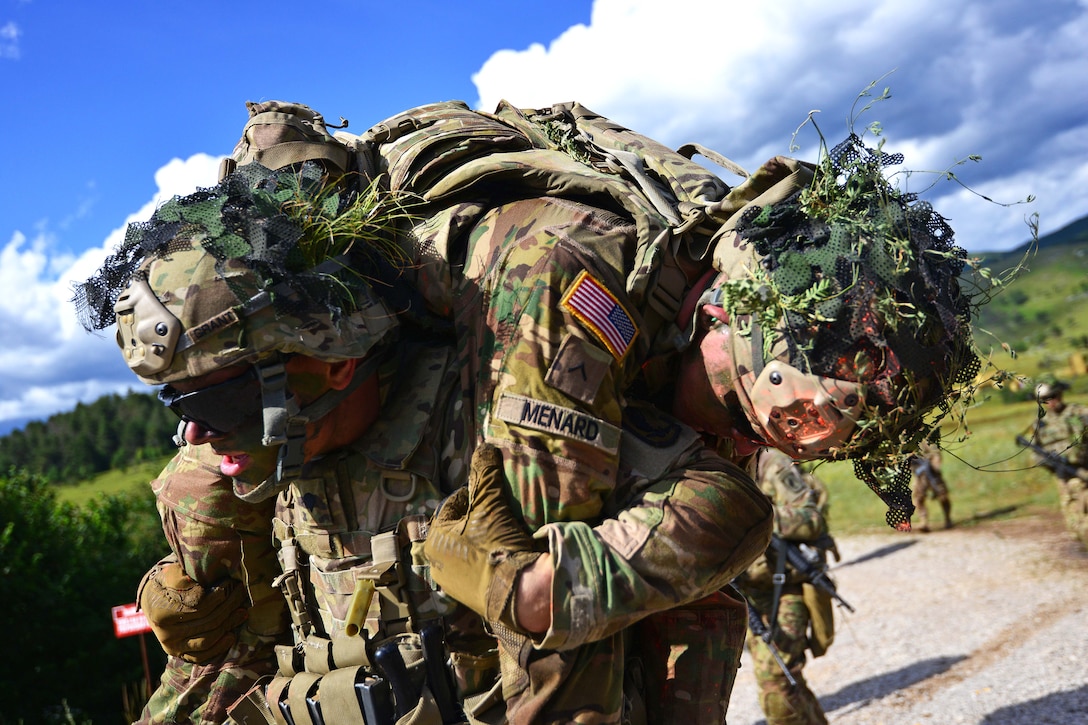 A paratrooper carries a mock casualty during a live-fire exercise as part of Exercise Rock Knight at Pocek Range in Postonja, Slovenia, July 25, 2017. Army photo by Davide Dalla Massara