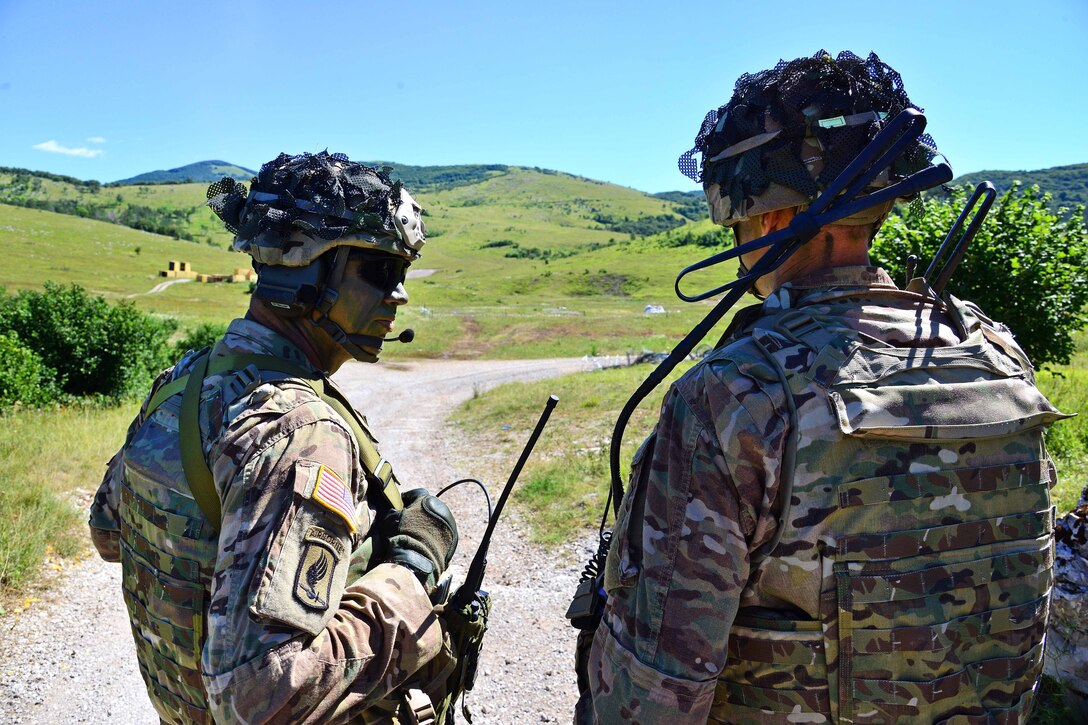 Army Lt. Col. Jim D. Keirsey, right, commander of 2nd Battalion, 503rd Infantry Regiment, 173rd Airborne Brigade, talks with Army Command Sgt. Maj. Wayne W. Wahlenmeier during a live-fire exercise as part of Exercise Rock Knight at Pocek Range in Postonja, Slovenia, July 25, 2017. Army photo by Paolo Bovo