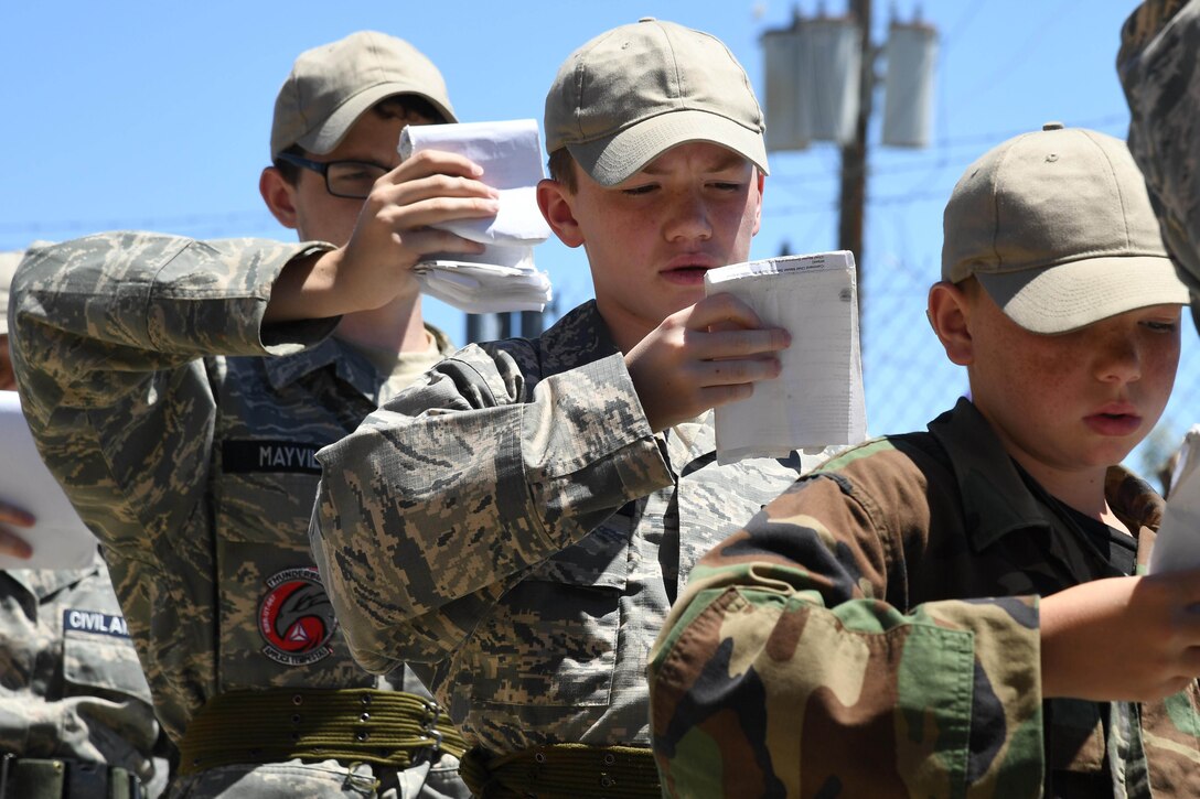 Civil Air Patrol cadets review their “smart books” while standing in line during the Desert Hawk XV encampment, Historic Wendover Airfield, Utah. Air Force photo by R. Nial Bradshaw