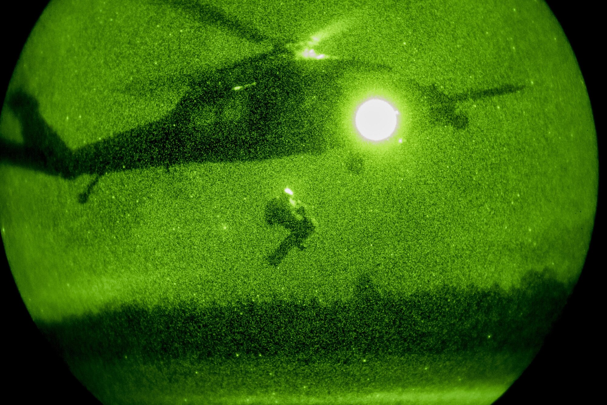 Pararescueman from the 38th Rescue Squadron extract a casualty into a hovering HH-60G Pave Hawk under the cover of darkness during a rescue exercise, June 21, 2017, at Bemiss Field landing zone, Ga. The Air Force Research Laboratory from Wright-Patterson Air Force Base, Ohio and the Baltimore U.S. Air Force Center for Sustainment of Trauma and Readiness Skills, observed Moody's Combat Search and Rescue aeromedical patient processes and survival kit technology, in hopes of reducing risks to improve the overall Air Force mission. (U.S. Air Force photo by Airman 1st Class Daniel Snider)  