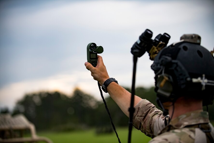 A Pararescueman from the 38th Rescue Squadron measure wind speed before his colleagues parachute out of a HC-130J Combat King II to initiate a rescue exercise June 21, 2017, at Bemiss Field landing zone, Ga. The Air Force Research Laboratory from Wright-Patterson Air Force Base, Ohio and the Baltimore U.S. Air Force Center for Sustainment of Trauma and Readiness Skills, observed Moody's Combat Search and Rescue aeromedical patient processes and survival kit technology, in hopes of reducing risks to improve the overall Air Force mission. (U.S. Air Force photo by Airman 1st Class Daniel Snider)