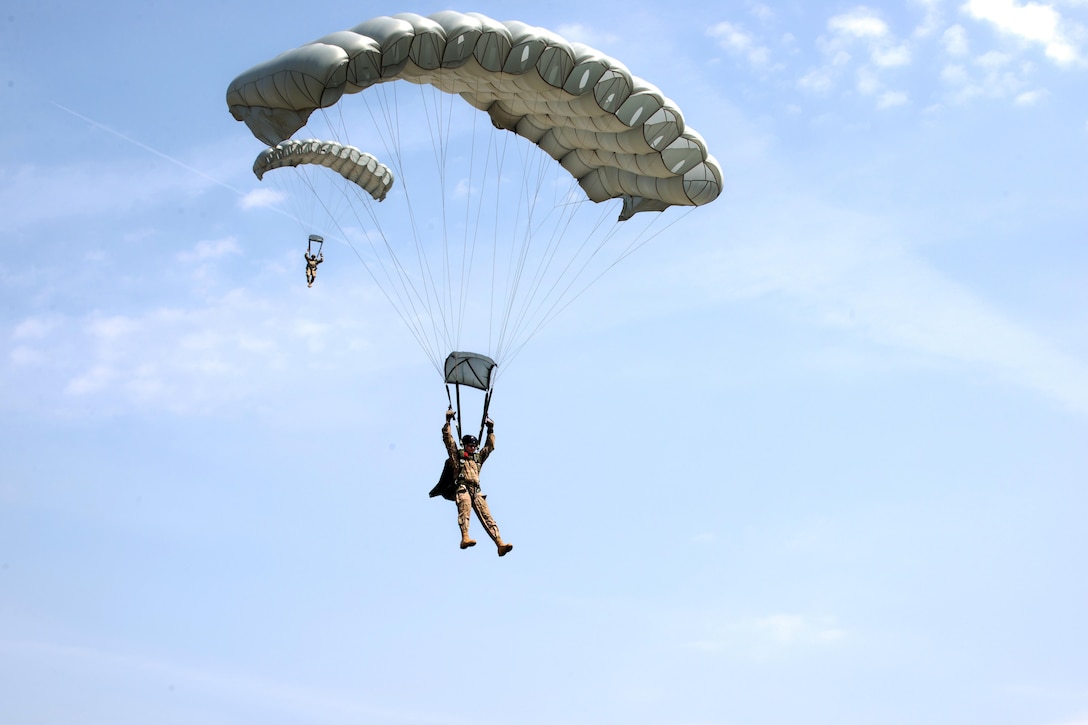 An U.S. special forces soldier parachutes onto an airfield during a combined airborne operation as part of Exercise Black Swan 2017 in Szolnok, Hungary, July 21, 2017. Special operations forces from the U.S., Hungary, and Romania conducted combined airborne operations during exercise Black Swan in Hungary, July 21, 2017. Army photo by Staff Sgt. Aaron Duncan