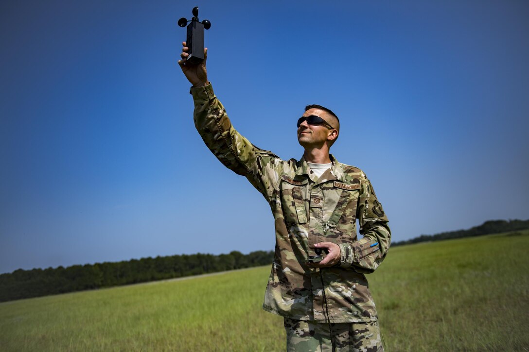 Tech. Sgt. John Schmidt, 820th Combat Operations Squadron NCO in charge of aircrew flight equipment, measures wind speed with an anemometer, July 21, 2017, at the Lee Fulp Drop Zone in Tifton, Ga. This training was in preparation for an upcoming mission readiness exercise where airborne advanced teams may parachute into an area to create an initial presence and clear a path for follow-on forces to arrive on scene. (U.S. Air Force photo by Airman 1st Class Daniel Snider)