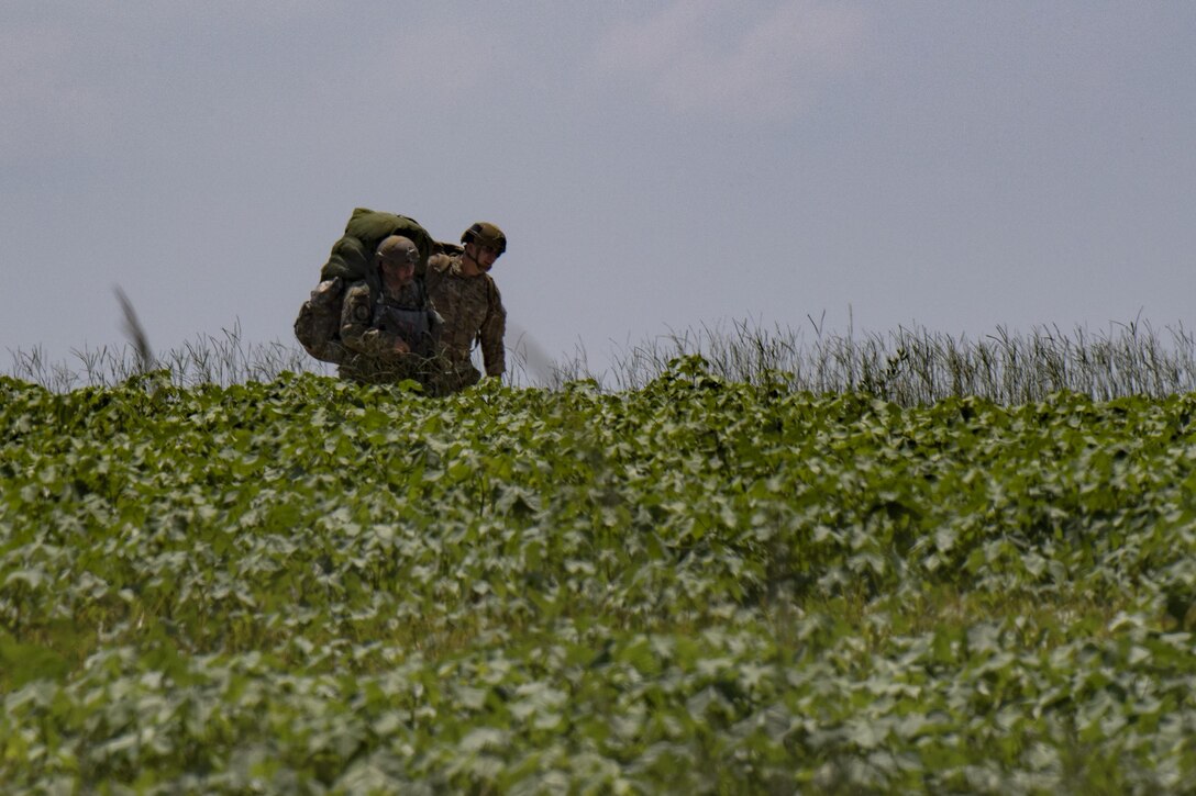 Members of the 823d Base Defense Squadron travel towards their rally point, July 21, 2017, at the Lee Fulp Drop Zone in Tifton, Ga. This training was in preparation for an upcoming mission readiness exercise where airmen serve as an airborne advanced team, with the mission to create an initial presence and clear a path for follow-on forces to arrive on scene. (U.S. Air Force photo by Airman 1st Class Daniel Snider)