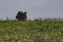 Members of the 823d Base Defense Squadron travel towards their rally point, July 21, 2017, at the Lee Fulp Drop Zone in Tifton, Ga. This training was in preparation for an upcoming mission readiness exercise where airmen serve as an airborne advanced team, with the mission to create an initial presence and clear a path for follow-on forces to arrive on scene. (U.S. Air Force photo by Airman 1st Class Daniel Snider)