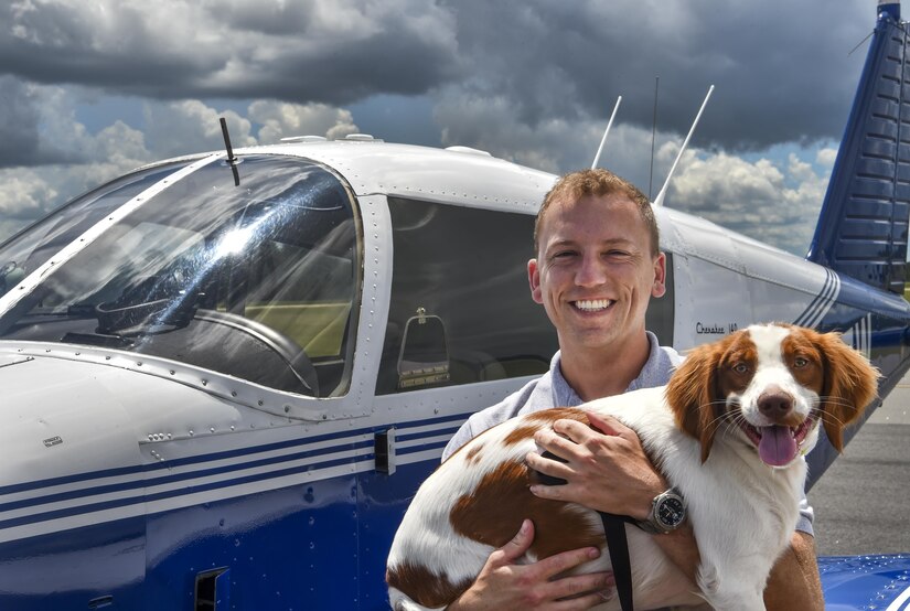 Maj. Ron Johnson, 437th Operations Support Squadron assistant director of operations and C-17 Globemaster III pilot, holds Zeus after a Pilots N’ Paws mission to Jacksonville Fl., July 22, 2017. Johnson partnered with Pilots N’ Paws to help take Zeus to a foster family.