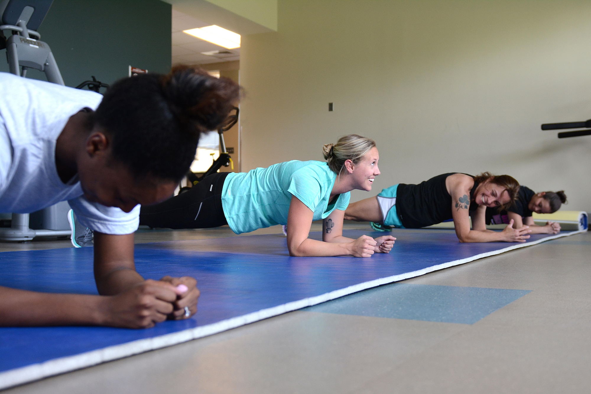 Second from left, Tech. Sgt. Kelsey Brunson, a fitness specialist from the 125th Force Support Squadron, leads the group in strength training during a fitness clinic July 20, 2017, at the 125th Fighter Wing in Jacksonville, Fla. Fitness comes easy for Brunson, who has a passion for working out. (U.S. Air National Guard photo by Staff Sgt. Carlynne DeVine)