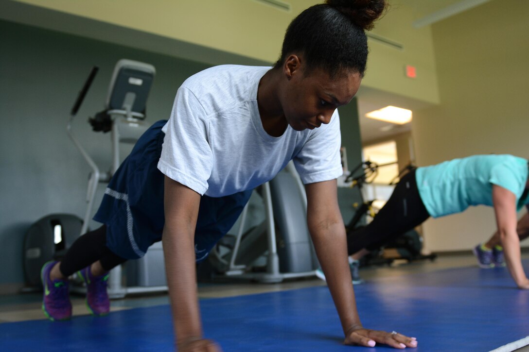 Staff Sgt. Ivett Samuels, a base services assistant from the 125th Force Support Squadron, partakes in strength training during a fitness clinic July 20, 2017, at the 125th Fighter Wing in Jacksonville, Fla. The 125 FSS started offering fitness clinics as a way to encourage everyone on base to be active and stay fit. (U.S. Air National Guard photo by Staff Sgt. Carlynne DeVine)