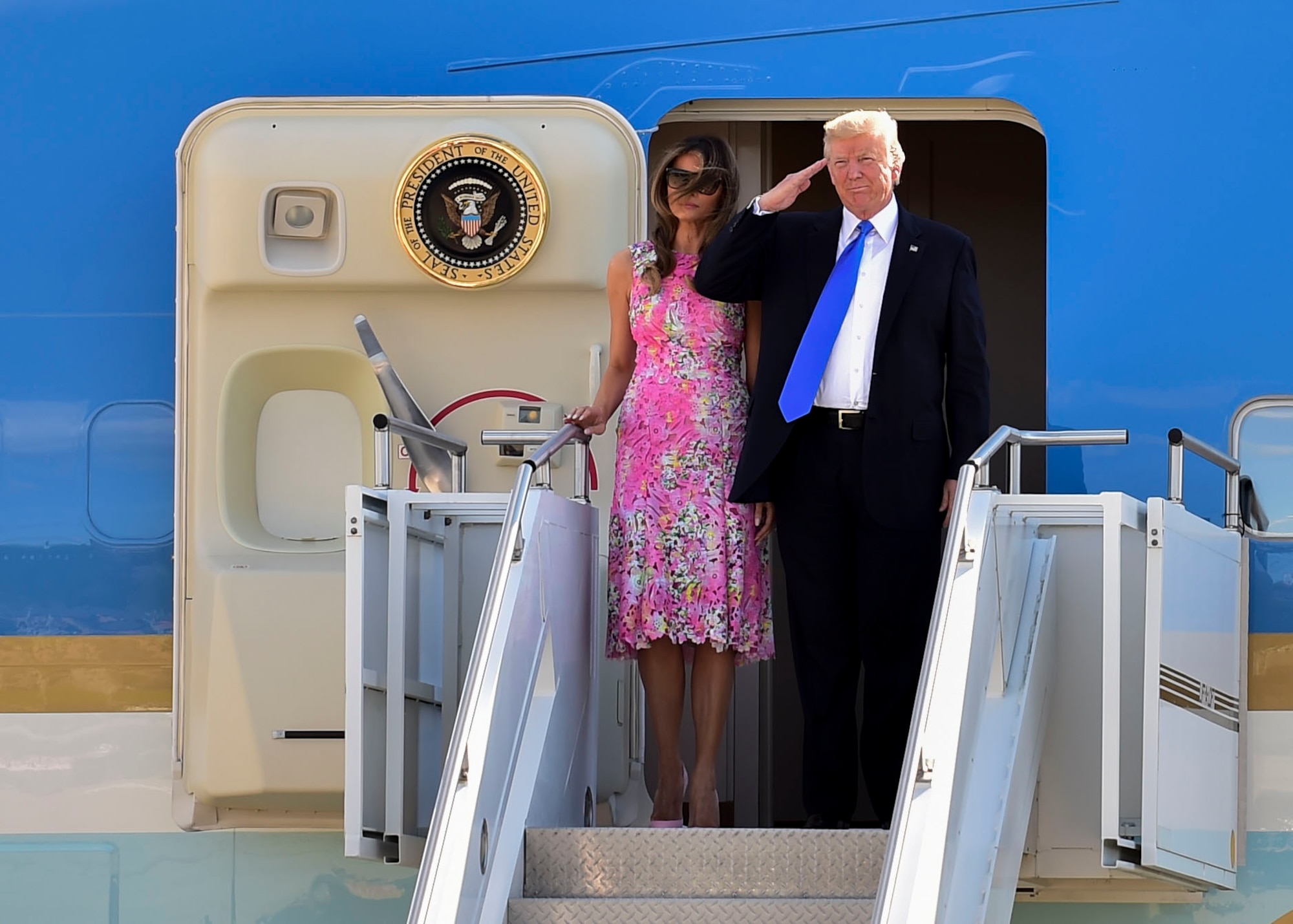 President Donald Trump renders a salute to Service members while standing next to First Lady Melania shortly after Air Force One landed here, July 25, 2017. Trump greeted Service members and guests before departing the station to attend events in and around the Youngstown, Ohio area. (U.S. Air Force photo/Senior Airman Jeffrey Grossi)