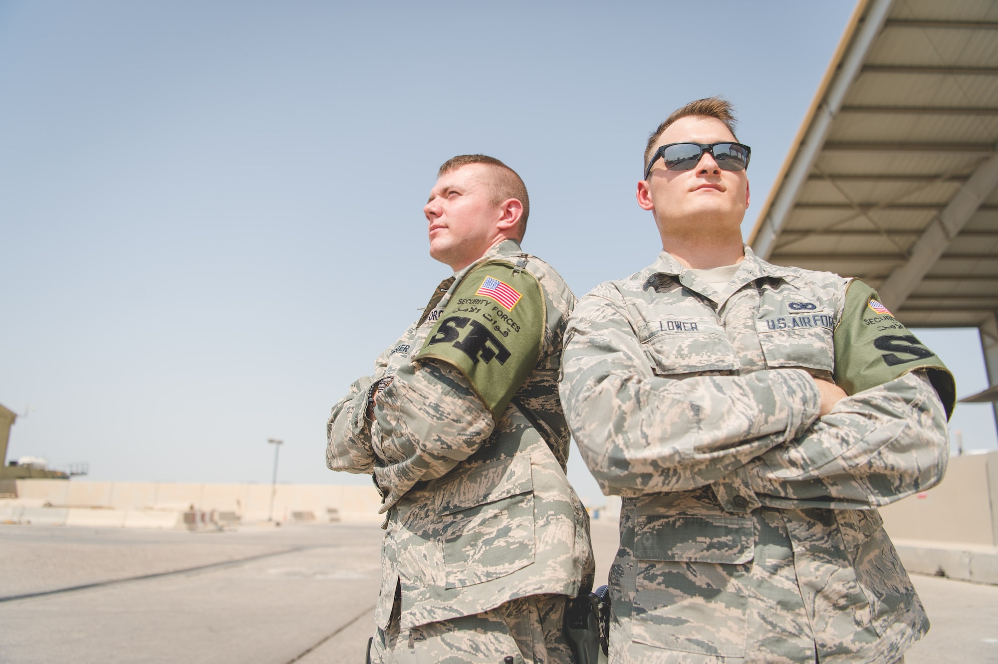 Airman 1st Class Reese Register (left) and Airman 1st Class William Lower, pose for a photo near the flightline Wednesday, July 26, 2017, at an undisclosed location in Southwest Asia. Register and Lower are both 387th Expeditionary Security Forces Squadron defenders who provided security for Secretary of State Rex Tillerson's recent visit to the region. (U.S. Air Force photo/1st Lt. Rashard Coaxum)