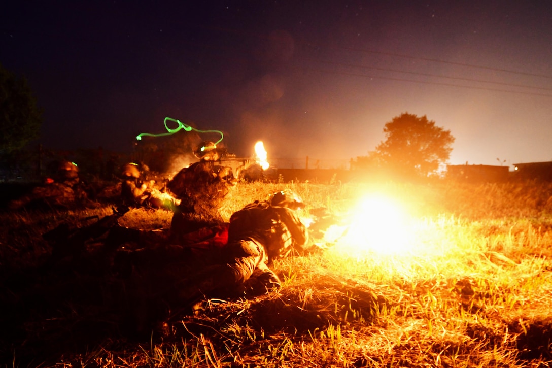 Italian army paratroopers fire blanks at Romanian opposition forces during Exercise Saber Guardian 17 in Turzii, Romania, July 22, 2017. Army photo by Sgt. Timothy Pike