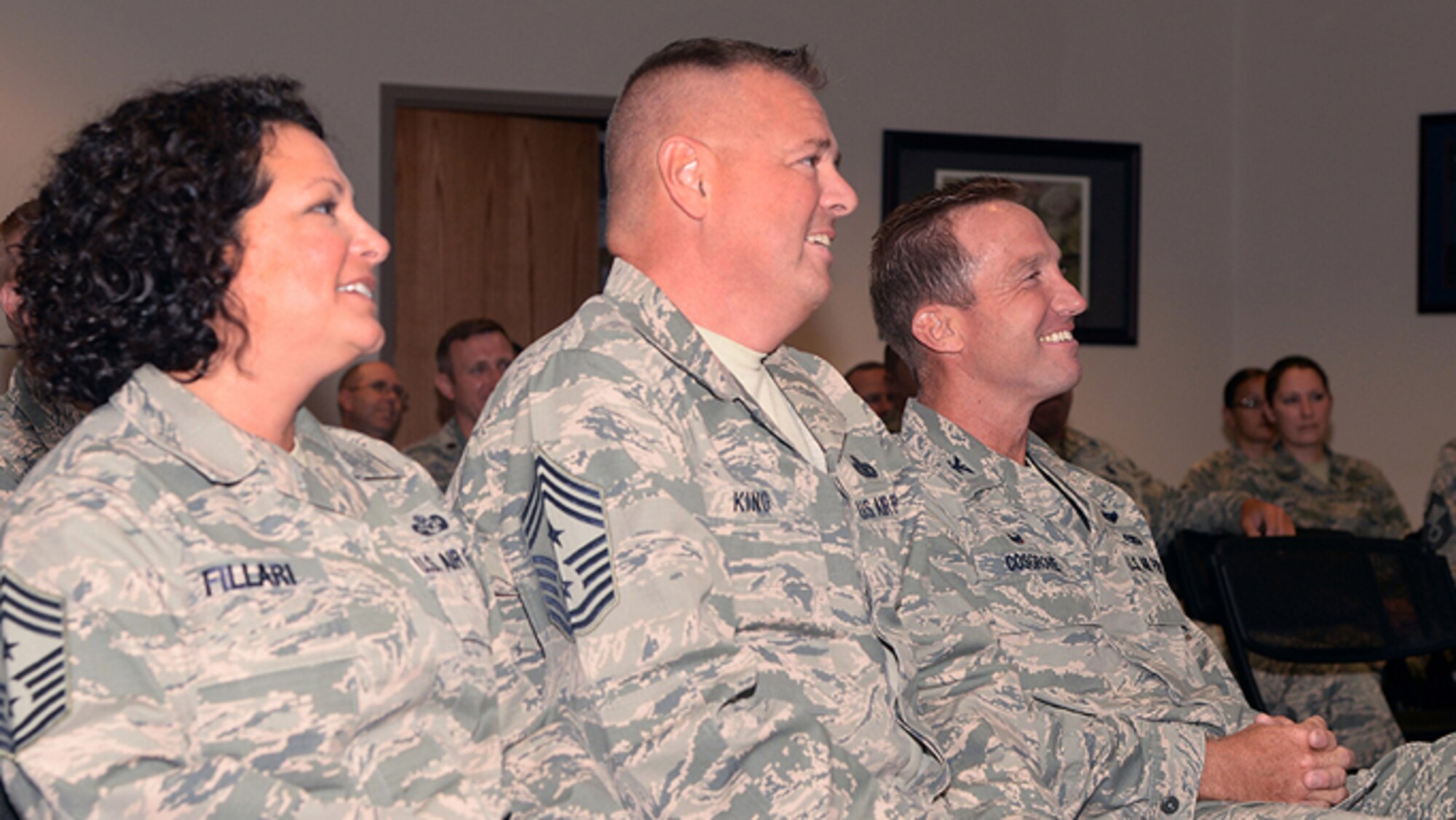 A picture of New Jersey Air National Guard Command Chief Master Sgt. Janeen Fillari, 1st Air Force Command Chief Master Sgt. Richard King and Col. John Cosgrove, maintenance group commander of the 177th Fighter Wing, attending an awards ceremony.