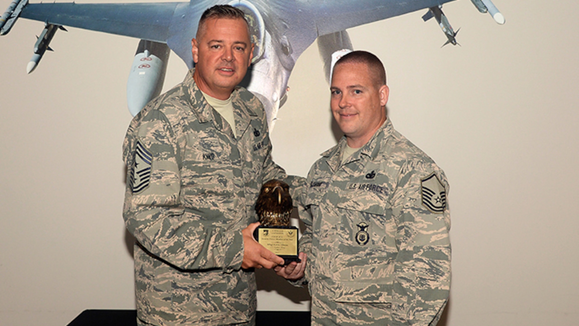 A picture of U.S. Air Force 1st Air Force Command Chief Master Sgt. Richard King presenting Master Sgt. Kevin Allman with the award for the Continental NORAD Region Aerospace Control Alert Security Forces Member of the Year.