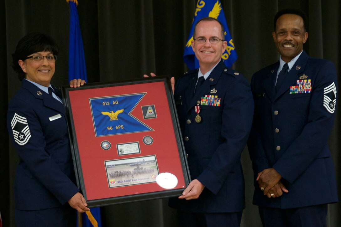 U.S. Air Force Reserve Chief Master Sgt. Cynthia Underwood, the air transportation superintendent for the 96th Aerial Port Squadron, Lt. Col. Jason Sheridan, and Chief Master Sgt. Alvin Glover, operations superintendent, 96 APS, pose for a photo during Sheridan’s retirement ceremony at Little Rock Air Force Base, Ark., July 8, 2017. Sheridan, a former 96 APS commander, retired after 22 years of service. (U.S. Air Force photo by Capt. Casey Staheli/Released)