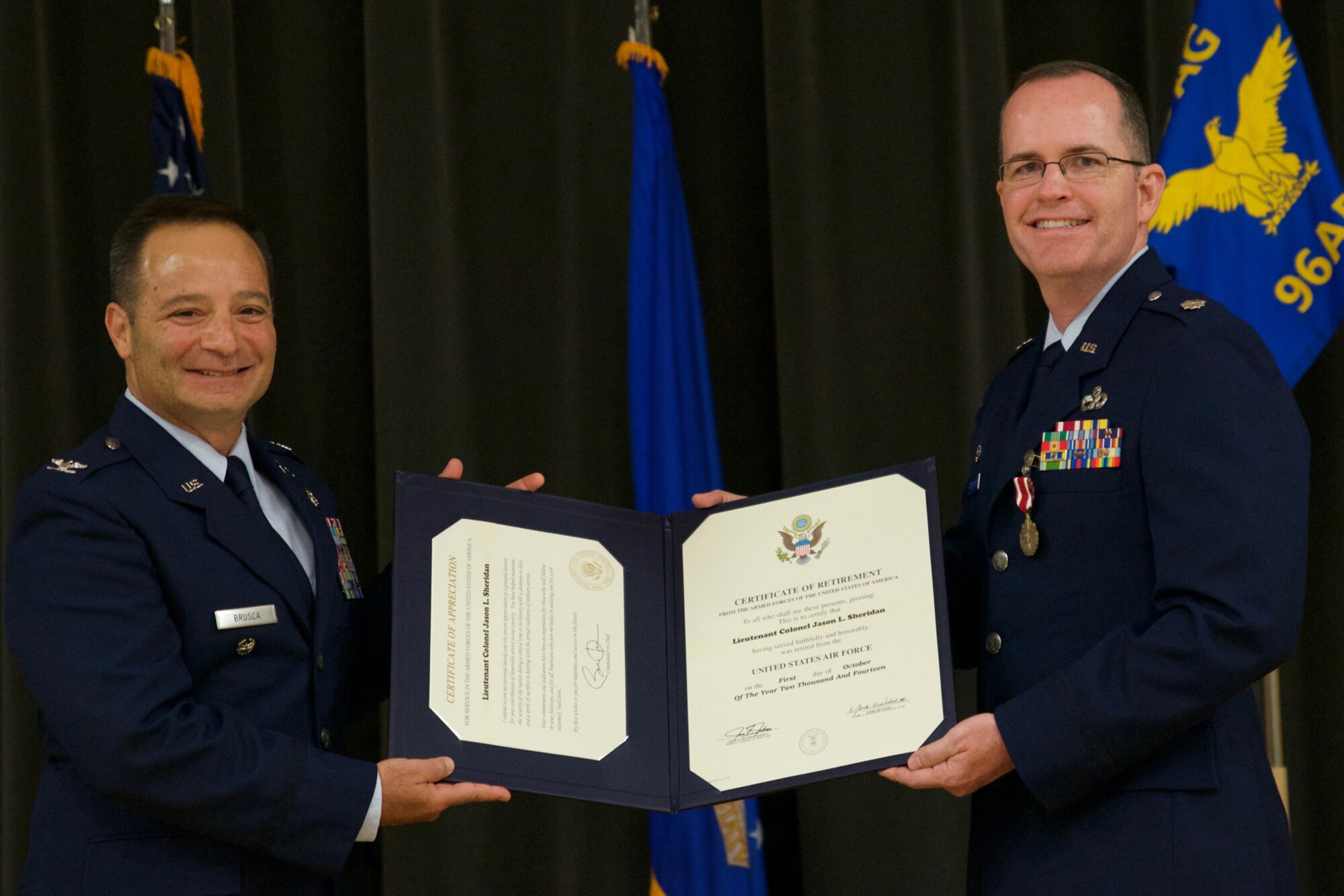 U.S. Air Force Reserve Col. Anthony Brusca, deputy commander for the 913th Airlift Group, and  
Lt. Col. Jason Sheridan, commander of the 96th Aerial Port Squadron, pose for a photo during a retirement ceremony at Little Rock Air Force Base, Ark., July 8, 2017. Sheridan, surrounded by family, friends and co-workers, retired after 22 years of service to his country. (U.S. Air Force photo by Capt. Casey Staheli/Released)