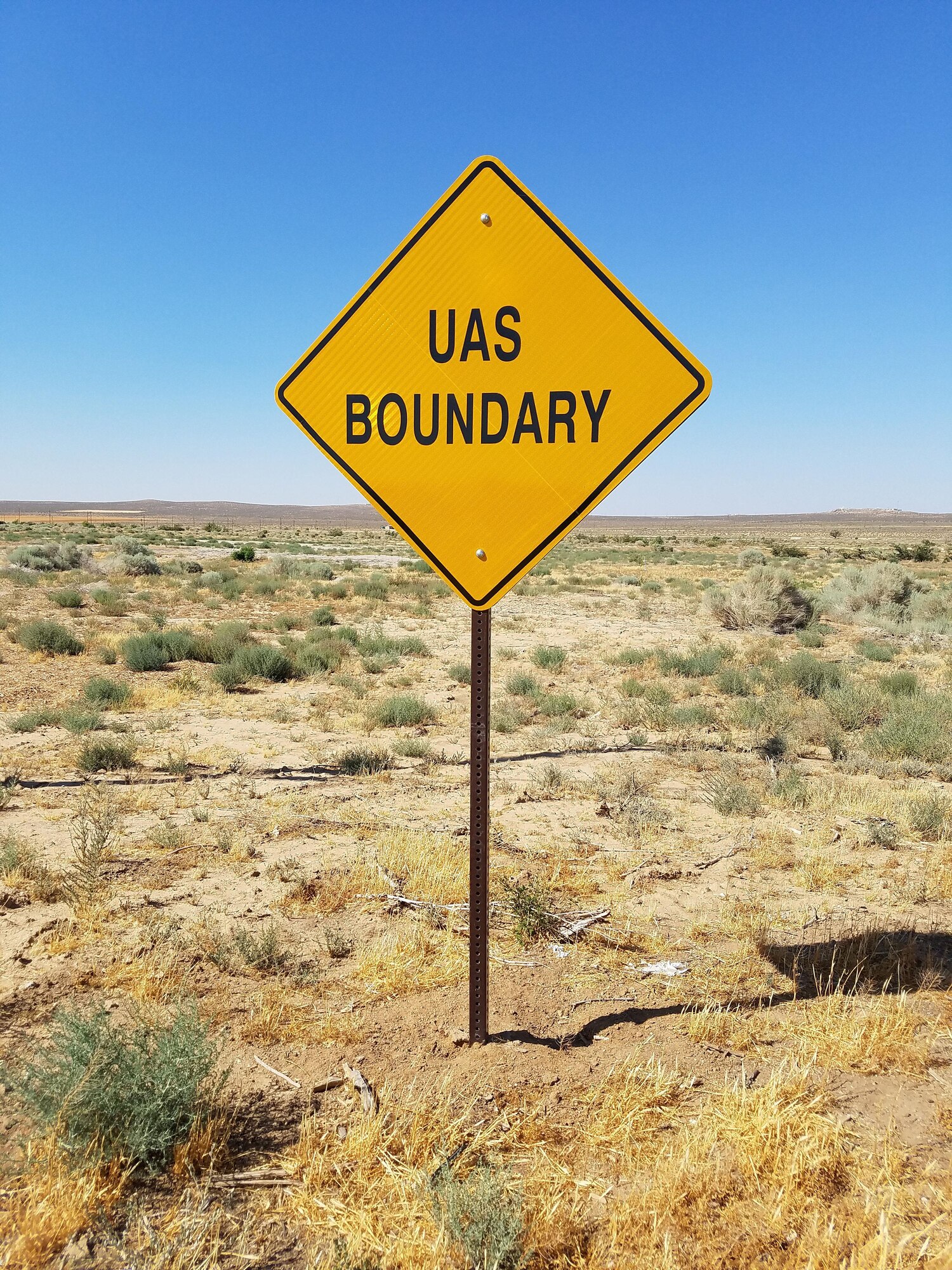 The Edwards AFB Personal Small UAS Area is located across the street from Desert Junior-Senior High School’s football field. The area dimensions are identified with metal posts stating “UAS Boundary.” In addition, the User’s Safety Code is posted at the site. (U.S. Air Force photo by Ed Buclatin)