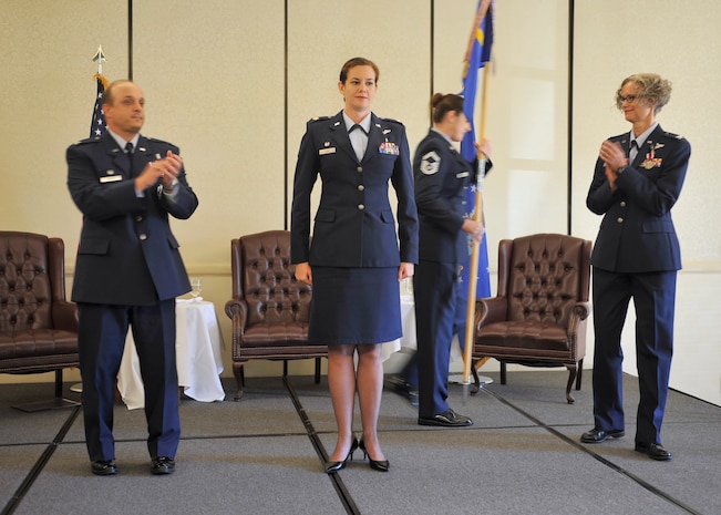 Maj. Mary Finn, 628th Aerospace Medicine Squadron incoming commander, receives applause after taking command of the 628th AMDS during a change of command ceremony here July 21. Finn served as the 48th Medical Group surgical services flight commander and chief of orthopaedic surgery, during her previous assignment at Royal Air Force Lakenheath, England. (U.S. Air Force photo by Senior Airman Kristin Kurtz)