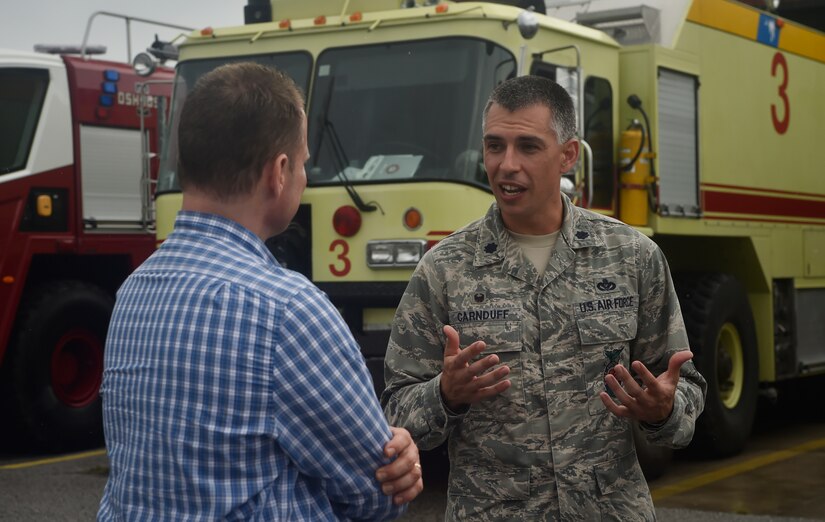 Lt. Col. Christopher Carnduff, right, 628th Civil Engineer Squadron commander, talks to Lt. Gov. of South Carolina Kevin Bryant, left, during a visit here, July 26. Bryant toured Joint Base Charleston to meet and thank military and civilian first responders for their service to the country and their efforts to support the local community. Bryant toured a C-17 Globemaster III, the installation fire department and received hands-on equipment familiarization from 628th CES explosive ordinance disposal team Airmen. (U.S. Air Force photo by Staff Sgt. Christopher Hubenthal)