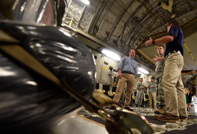 Kenneth Hundemer, right, 437th Aerial Port Squadron, briefs Lt. Gov. of South Carolina Kevin Bryant, left, and Col. Jeff Nelson, center, 628th Air Base Wing commander, during a tour of a C-17 Globemaster III as part of a visit here, July 26. Bryant toured Joint Base Charleston to meet and thank military and civilian first responders for their service to the country and their efforts to support the local community. Bryant toured a C-17 Globemaster III, the installation fire department and received hands-on equipment familiarization from 628th Civil Engineer Squadron explosive ordinance disposal team Airmen. (U.S. Air Force photo by Staff Sgt. Christopher Hubenthal)