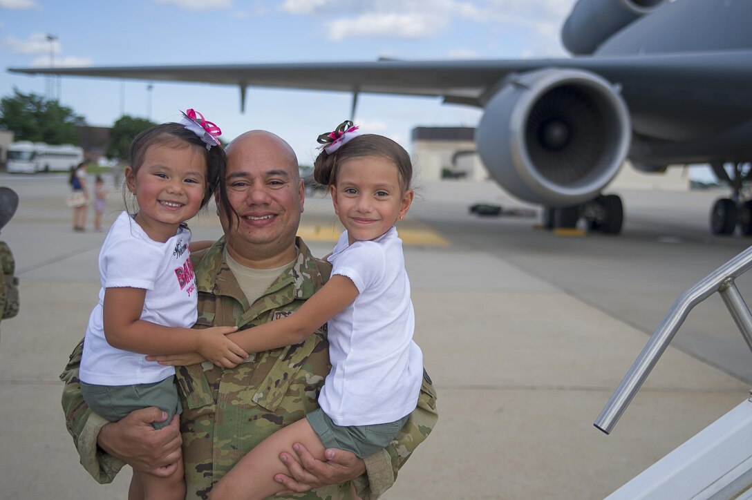 Master Sgt. Christopher Baez, 78th Air Refueling Squadron, poses with his daughters, Brianna and Tatiana. 514th Air Mobility Wing air crew and maintainers returned from their respective two-month and four-month deployments to Southwest Asia July 26. (U.S. Air Force photo by Christian DeLuca/released)