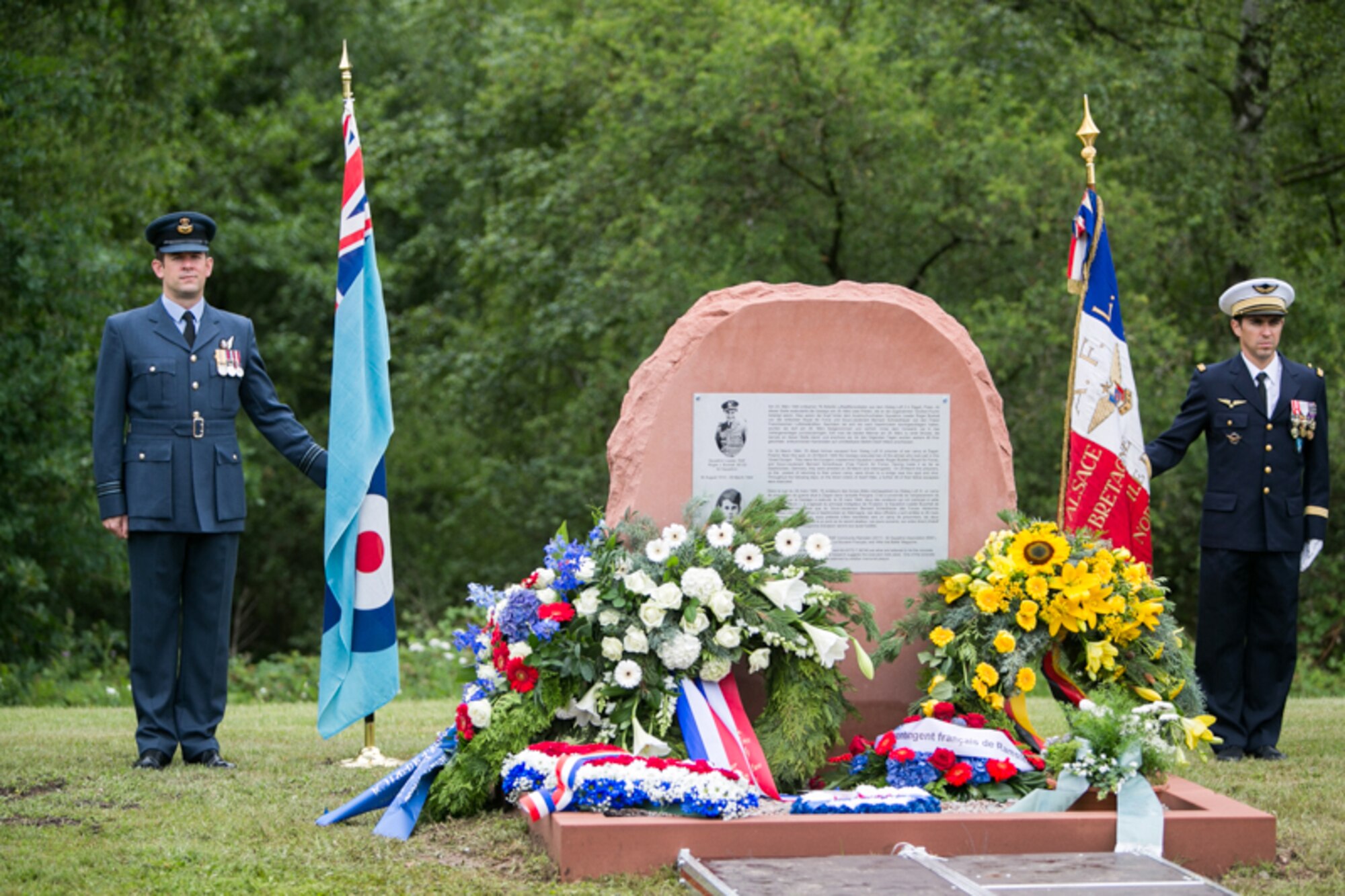 Royal Air Force and French Air Force Honor Guards stand next to a monument dedicated to the memory of RAF Squadron leader Roger Bushell and FAF 2nd Lt. Bernad Scheidhauer, July 1, 2017.  Both men were part of the “Great Escapees,” who were executed by the Gestapo on March 29, 1944 near present-day Ramstein Air Base. (U.S. Air Force photo by Staff Sgt. Timothy Moore)