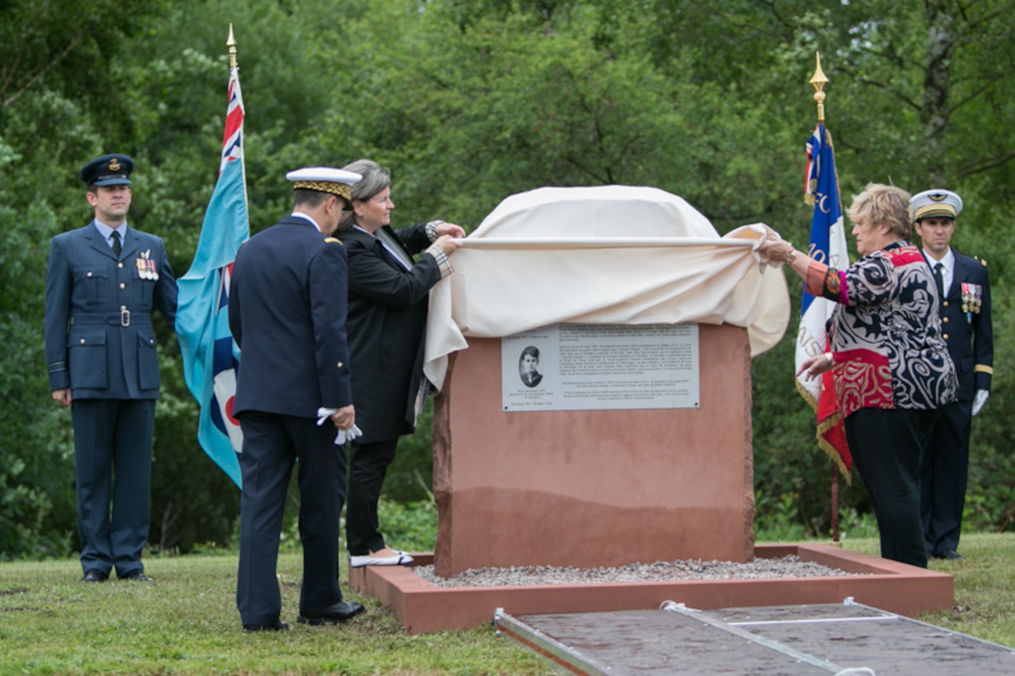 Christelle Magnee, French Air Force 2nd Lt. Bernad Scheidhauer’s great niece, and Caroline Kennard, Royal Air Force Squadron leader Roger Bushell’s niece, unveil a memorial to their relatives on July 1, 2017 outside Ramstein, German. Bushell and Scheidhauer were among the 76 Allied prisoners of war who had escaped from Luft Stalag III at Sagan, Germany (now Poland) on March 24, 1944, in what became known as “The Great Escape.”  (U.S. Air Force photo by Staff Sgt. Timothy Moore)