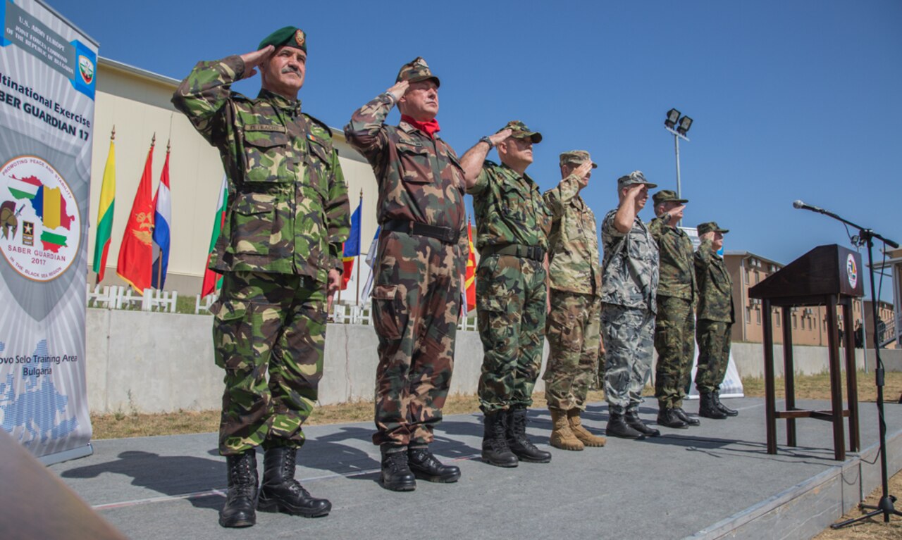 Leaders from participating nations render honors for the host nations' national anthems during the opening ceremony for exercise Saber Guardian 17 at Novo Selo Training Area, Bulgaria, July 11, 2017. Saber Guardian is a U.S. Army Europe-led, multinational exercise that spans across Bulgaria, Hungary, and Romania with more than 25,000 service members 22 allied and partner nations. Army photo by Spc. Jada Owens
