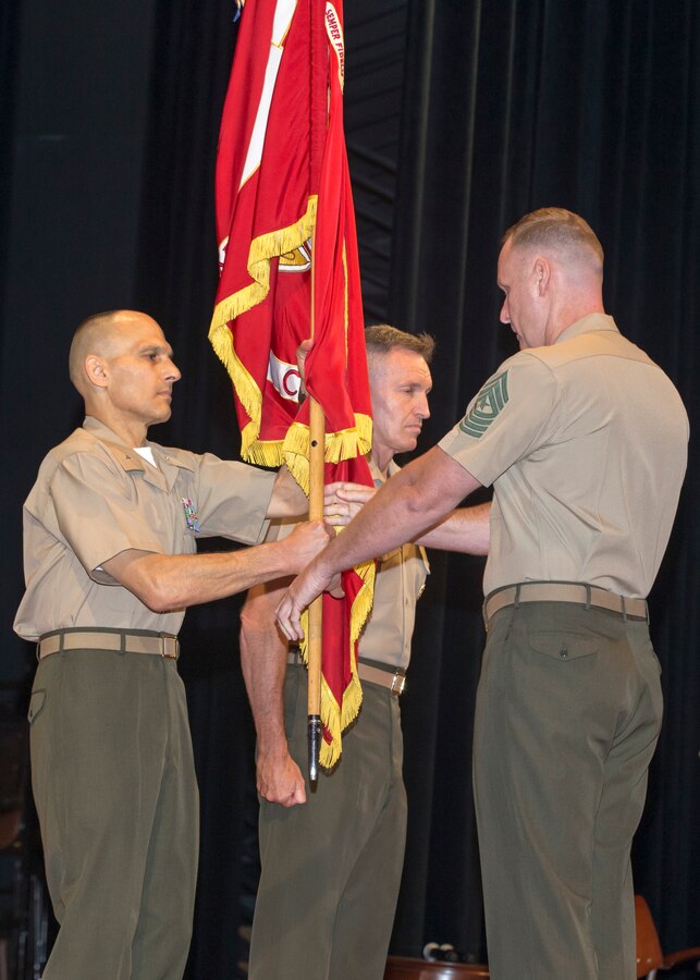 U.S. Marine Corps Sgt. Maj. David Maddux, right, sergeant major, Education Command (EDCOM), passes the organizational colors to Brig. Gen. Thomas Gorry, outgoing commanding general, EDCOM, during a change of command ceremony in which Brig. Gen. William Bowers became the new commanding general  at Warner Hall Auditorium, Marine Corps University, Quantico, Va., July 21, 2017.  (U.S. Marine Corps photo by Cpl. Jacqueline A. Garcia)