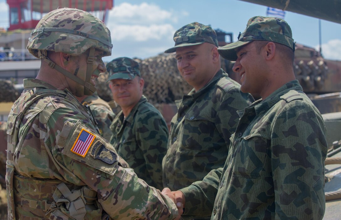 Lt. Gen. Ben Hodges, commander, U.S. Army Europe, shakes hands with a Bulgarian T-72 tank crew after of a combined arms live fire exercise during Saber Guardian 17, at Novo Selo Training Area, Bulgaria, July 20, 2017. Saber Guardian is a U.S. Army Europe-led, multinational exercise that spans across Bulgaria, Hungary and Romania with more than 25,000 service members from 22 allied and partner nations.  (U.S. Army photo by Spc. Jada Owens)