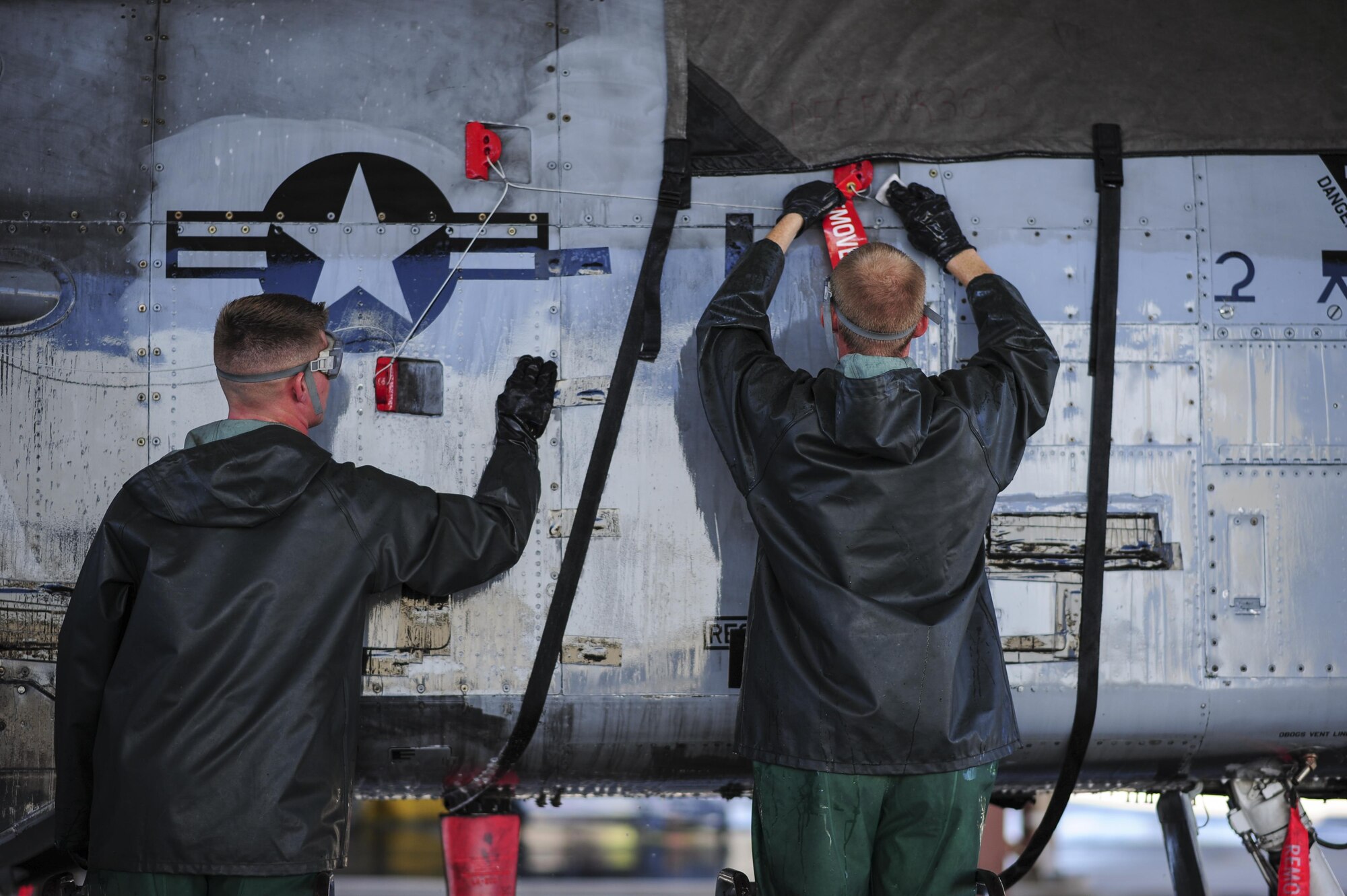 U.S. Air Force Airman 1st Class Jacob Mitchell and Senior Airman Caleb Mathre, 354th Aircraft Maintenance Unit airframe power plant general crew chiefs, clean an A-10C Thunderbolt II at Davis-Monthan Air Force Base, Ariz., July 25, 2017. The cleaning process can take crew chiefs three to four hours to complete. (U.S. Air Force photo by Airman 1st Class Michael X. Beyer)