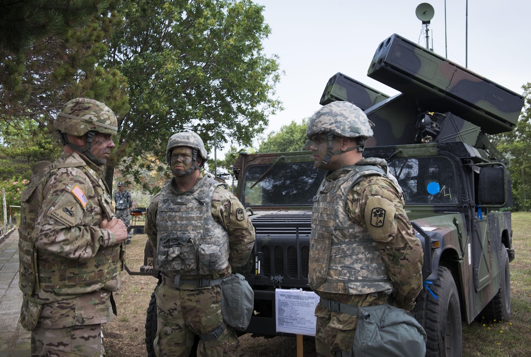 Col. David Shank, commander of the 10th Army Air and Missile Defense Command, speaks with Avenger team leader Army Sgt. Jesse Thomas and Avenger team member Army Spc. Dillion Whitlock with Charlie Battery, 2nd Battalion, 63rd Armored Regiment, South Carolina National Guard, during an air-defense live-fire exercise in Shabla, Bulgaria, July 18, 2017. The event comes as part of Tobruq Legacy 17, a multinational air defense exercise that demonstrates interoperability and communication between NATO allies and partners. DoD photo by Marine Corps Staff Sgt. Ben Flores