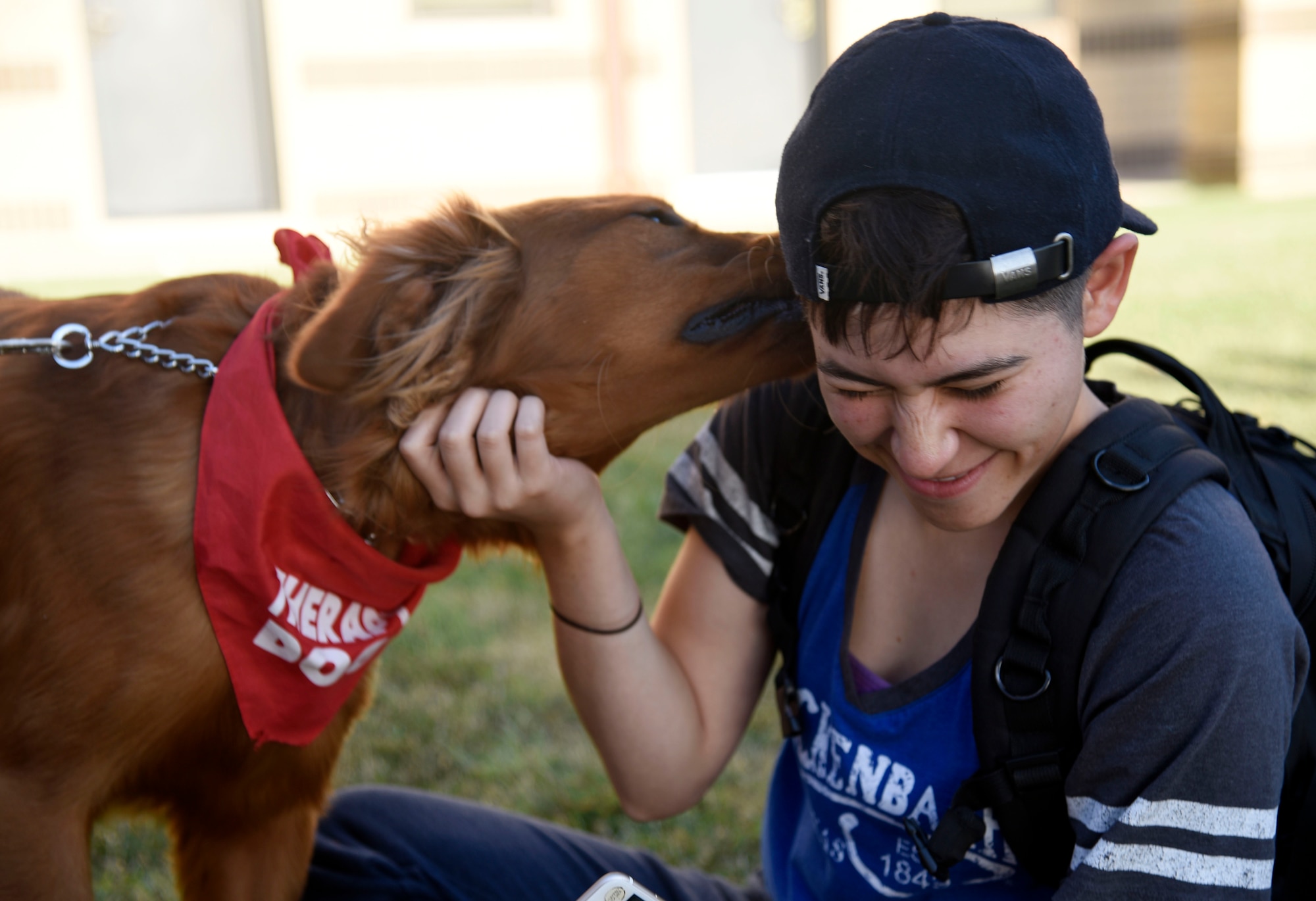 Airman Angela Alanis, 22nd Logistics Readiness Squadron materiel management technician, interacts with a therapy dog, July 25, 2017, at McConnell Air Force Base, Kan. Four therapy dogs and their owners from Love on a Leash visited dorm residents to increase morale. (U.S. Air Force photo/Airman 1st Class Erin McClellan)