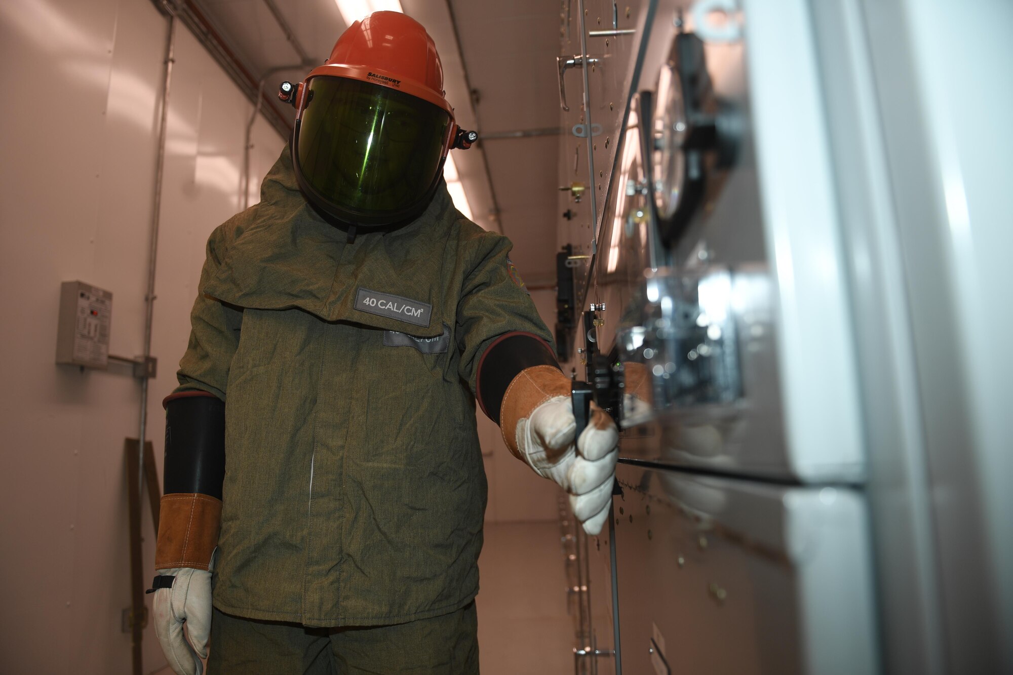 Airman 1st Class Gavin Verhoeven, an electrician with the 87th Civil Engineer Squadron, performs preventative maintenance at a power substation following an explosion at the main power station earlier this month at Joint Base McGuire-Dix-Lakehurst, New Jersey, July 27, 2017. The protective equipment shown is designed to protect Airmen from the potentially dangerous electricity they work with every day.