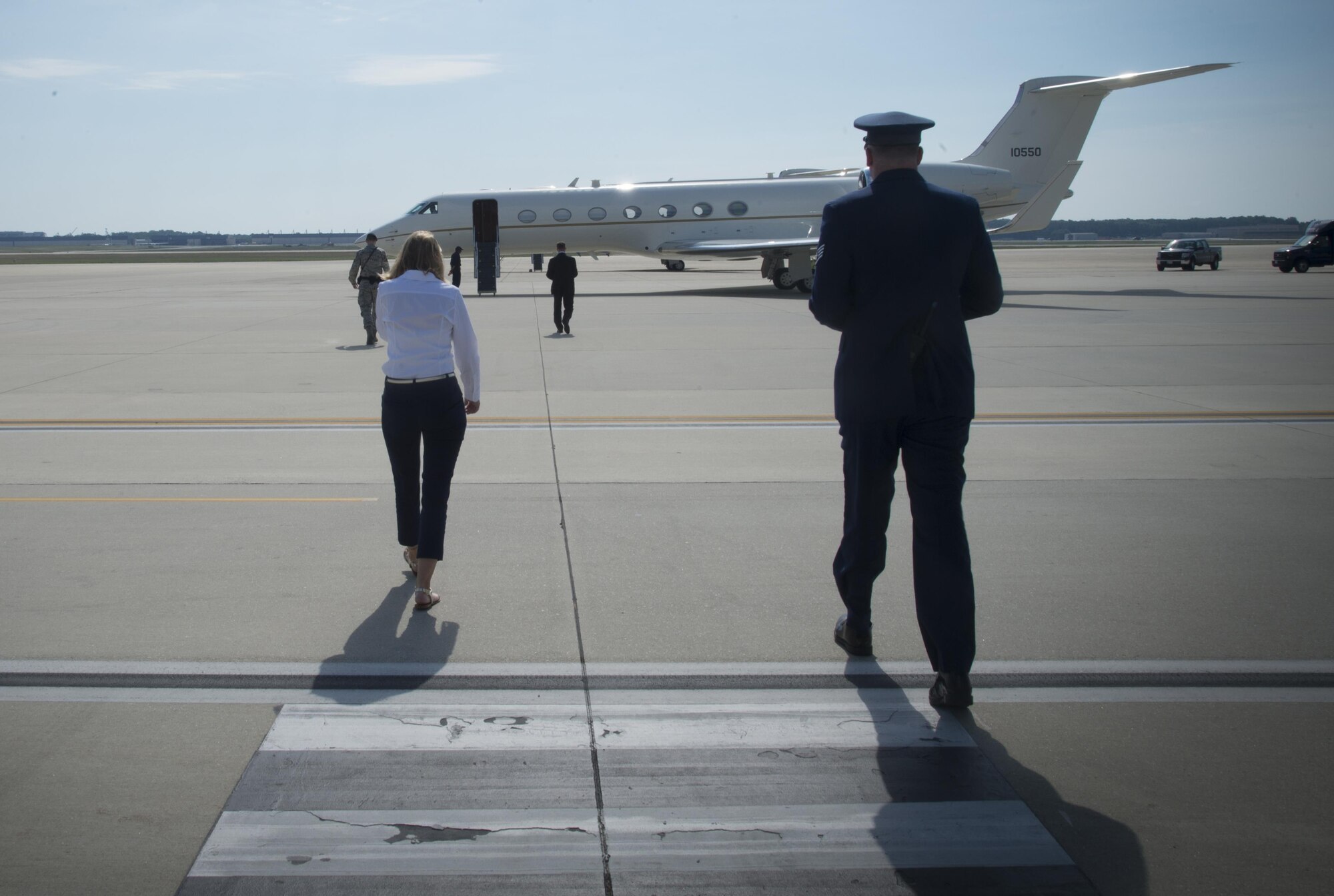 Katie Maynard, 89th Airlift Wing flight line protocol specialist (left), walks out to the flight line to greet an arriving distinguished visitor June 22, 2017, at Joint Base Andrews, Md. Airmen of the 89th AW flight line protocol office support more than 43,000 foreign and domestic dignitaries and staff. The Airmen also support approximately 3,500 distinguished visitor missions yearly. 