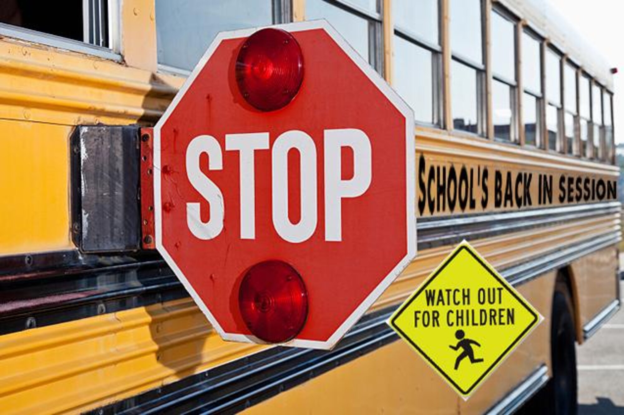 Lowndes County schools will start back up beginning Aug. 1. Be on the lookout for students who may be traveling to or from school. Always stop when you see flashing lights on a school bus and do not proceed to drive until the bus turns off its flashing lights. (Photo illustration by Airman 1st Class Lauren M. Sprunk)
