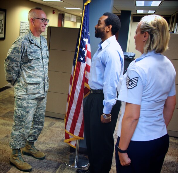 Ready to ship off to basic military training camp?  Lt. Col. Stan Paregien listens to one of the wing's newest recruits, Derek Wise, as he recites his mandatory reporting statement following his enlistment.  He raised his right hand and enlisted into the Air Force Reserve Command and the 932nd Airlift Wing on July 24, 2017 at Scott Air Force Base, Illinois.  His recruiter and adviser, Tech. Sgt. Nikki Seibel, also stands at attention and listens to the statement as a review before he goes off to basic training.
(U.S. Air Force photo by Master Sgt. Dawnmosha Williams, 932nd Health Professional Recruiter)
