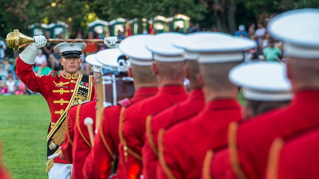 Marine Corps Master Sgt. Keith Martinez conducts the Marine Drum and Bugle Corps during a sunset parade at the Marine Corps War Memorial in Arlington, Va., July 25, 2017. Martinez is an assistant drum major. Marine Corps photo by Cpl. Robert Knapp