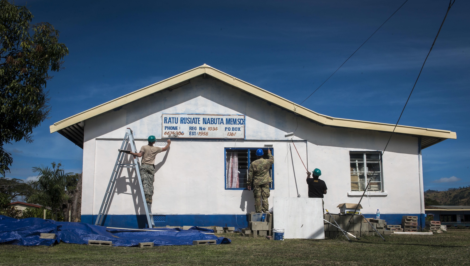 U.S. Air Force Senior Airman Tristan Fournier, a structural journeyman with the 374th Civil Engineer Squadron at Yokota Air Base, Japan, left, U.S. Army Staff Sgt. Brad Munden, a construction supervisor with the 523rd Engineer Company at Schoefield Barracks, Hawaii, center, and a Republic of Fiji Military Force engineer, right, repaint the Ratu Rusiate Nabuta Memorial School’s exterior during Pacific Angel 17-3 in Ba, Fiji, July 18, 2017. The three worked side-by-side to repaint the entire school’s exterior. The U.S. is dedicated to working together with Fiji and other nations and organizations to build capacity and partnership in the Indo-Asia-Pacific region. (U.S. Air Force photo/Tech. Sgt. Benjamin W. Stratton)