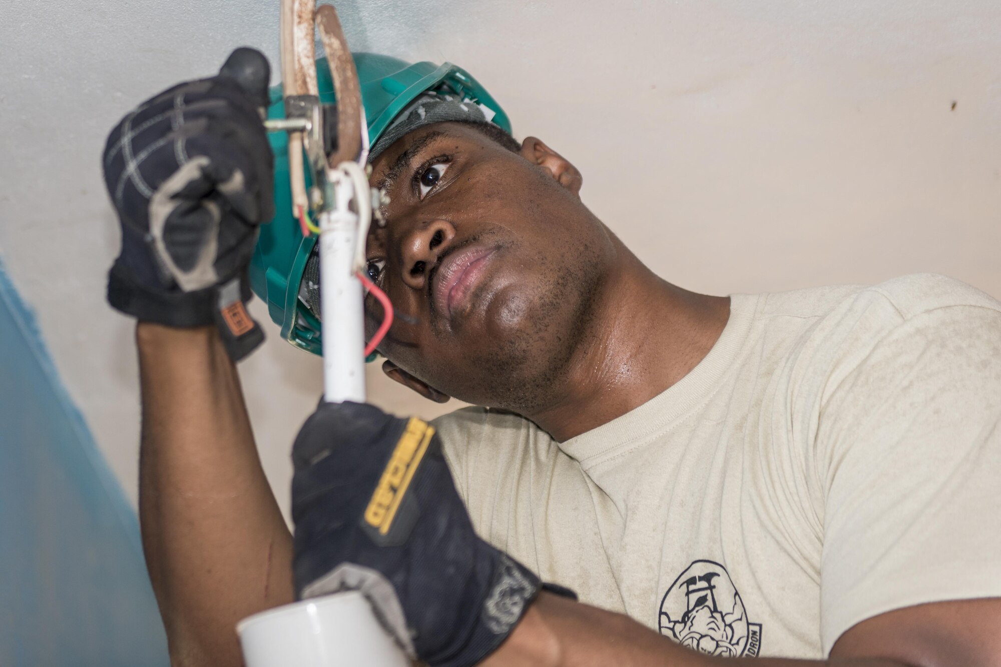 U.S. Air Force Staff Sgt. Quintin Robinson, an electrician with the 374th Civil Engineer Squadron at Yokota Air Base, Japan, rewires a ceiling fan at Khalsa Primary School during Pacific Angel (PACANGEL) 17-3 in Ba, Fiji, July 18, 2017. Robinson joined two U.S. Air Force water and fuels specialists and their Fijian counterparts in Ba, working hand-in-hand to ensure the children and their teachers could have operable ceiling fans and running water. PACANGEL 17-3 strengthens participating armed forces and nongovernmental organizations interoperability so they can be ready in the event of an unforeseen natural disaster such as the cyclone that hit Fiji in 2015. (U.S. Air Force photo/Tech. Sgt. Benjamin W. Stratton)