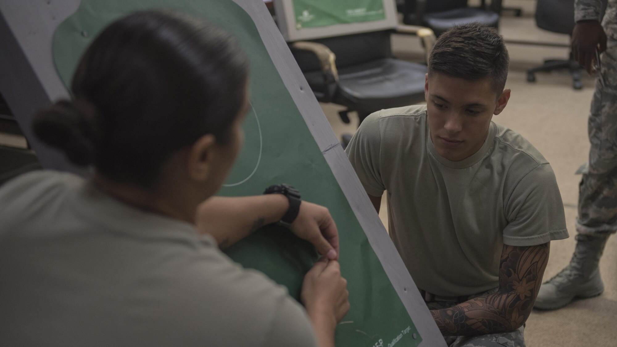 U.S. Air Force Airman 1st Class Antonio Lim, 18th Security Forces Squadron defender, receives instructions on how to remove the Taser points from the target during Taser and oleoresin capsicum (OC)  spray training July 20, 2017, at Kadena Air Base, Japan. Removing the points requires careful precision as they can get stuck into the target and require surgery to remove. (U.S. Air Force photo/ Airman 1st Class Greg Erwin)