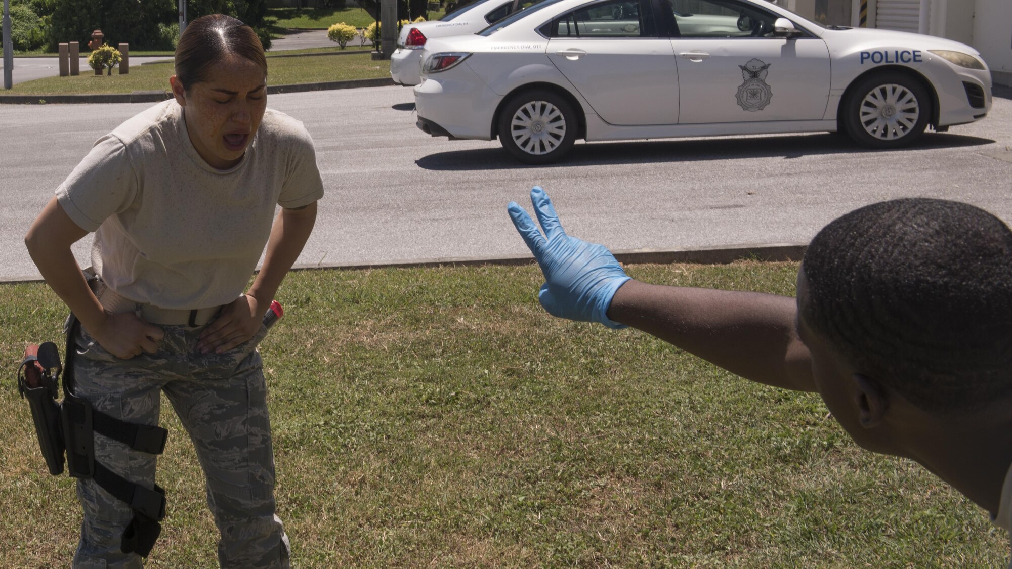 U.S. Air Force Airman 1st Class Vanessa Nava, 18th Security Forces defender, is asked to say how many fingers she can see during Taser and oleoresin capsicum (OC)  spray training July 20, 2017, at Kadena Air Base, Japan. The OC spray causes a temporary blindness that helps assist in apprehension. (U.S. Air Force photo/ Airman 1st Class Greg Erwin)
