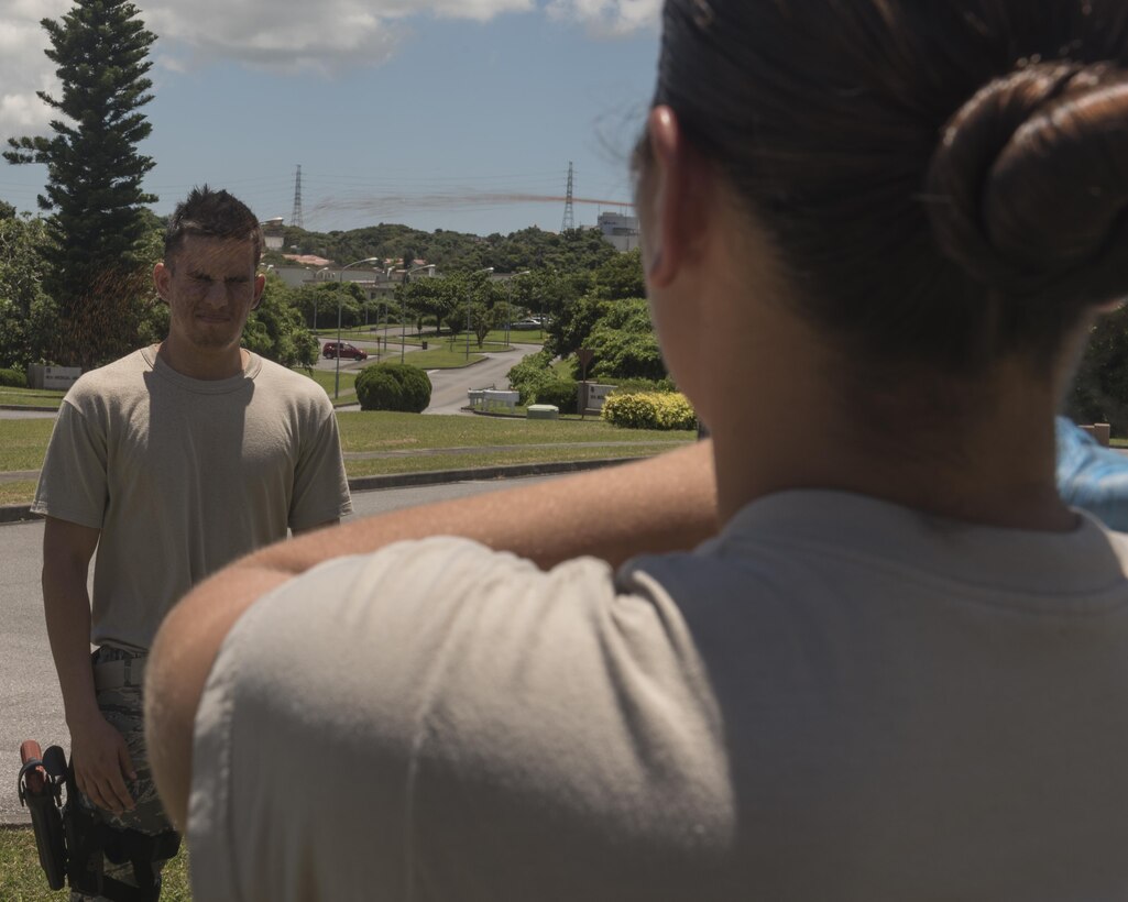 U.S. Air Force Airman 1st Class Luis Bernal, 18th Security Forces Squadron defender, is OC sprayed in the face during Taser and oleoresin capsicum (OC)  spray training July 20, 2017, at Kadena Air Base, Japan.  The OC spray, similar to pepper spray, is comparable in heat to hot peppers such as the Cayenne pepper and the Carolina Reaper.  (U.S. Air Force photo/ Airman 1st Class Greg Erwin)