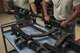 A U.S. Air Force Airman from the 33rd Helicopter Maintenance Unit places a GAU-18 50-caliber machine gun on a cart July 26, 2017, at Kadena Air Base, Japan. Armament Airmen work on the flightline and in the back-shop 24/7 in order to provide combat, counter-air capabilities to every HH-60 Pave Hawk in the 33rd Rescue Squadron. (U.S. Air Force photo by Senior Airman John Linzmeier)