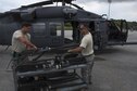 U.S. Air Force Staff Sgt. Ryan Anderson and Tech. Sgt. Josean Arce, 33rd Helicopter Maintenance Unit weapons section weapons technicians, ready a GAU-18 50-caliber machine gun to be loaded onto an HH-60 Pave Hawk from the 33rd Rescue Squadron July 26, 2017, at Kadena Air Base, Japan. When mounted to an HH-60 Pave Hawk, the weapons are manned by special mission aviators for real-world and training operations. (U.S. Air Force photo by Senior Airman John Linzmeier)