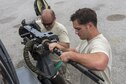 U.S. Air Force Senior Airman Zachary Hough and Staff Sgt. Ryan Anderson, 33rd Helicopter Maintenance Unit weapons section weapons load technicians, load a GAU-18 50-caliber machine gun onto an HH-60 Pave Hawk from the 33rd Rescue Squadron July 26, 2017, at Kadena Air Base, Japan. The GAU-18’s mobile design allows it to be mounted on an HH-60 Pave Hawk and is capable of firing 650 to 750 rounds per-minute. (U.S. Air Force photo by Senior Airman John Linzmeier)