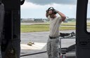 U.S. Air Force Tech. Sgt. Josean Arce, 33rd Helicopter Maintenance Unit weapons section weapons expediter, dawns ear protection as his team arms an HH-60 Pave Hawk from the 33rd Rescue Squadron July 26, 2017, at Kadena Air Base, Japan. The 33rd RQS plays a vital part in maintaining peace and stability in the Pacific Region by providing forward power projection as well as search, rescue and recovery mission capabilities. (U.S. Air Force photo by Senior Airman John Linzmeier)