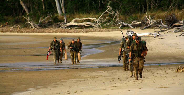 Soldiers from Charlie Troop, 2nd Battalion, 101st Cavalry Squadron, of the New York Army National Guard, patrol along the beach at Shoalwater Bay, Queensland, Australia, during exercise Talisman Saber, July 14, 2017. During the exercise New York Army National Guard Soldiers fought both against, and alongside Australian Defense Force soldiers in a series of war games. (U.S. Army National Guard photo by Sgt. Alexander Rector)